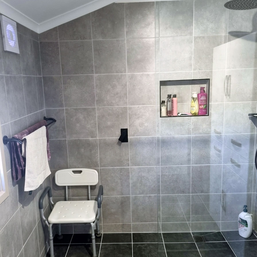 grey-tiled, newly renovated shower