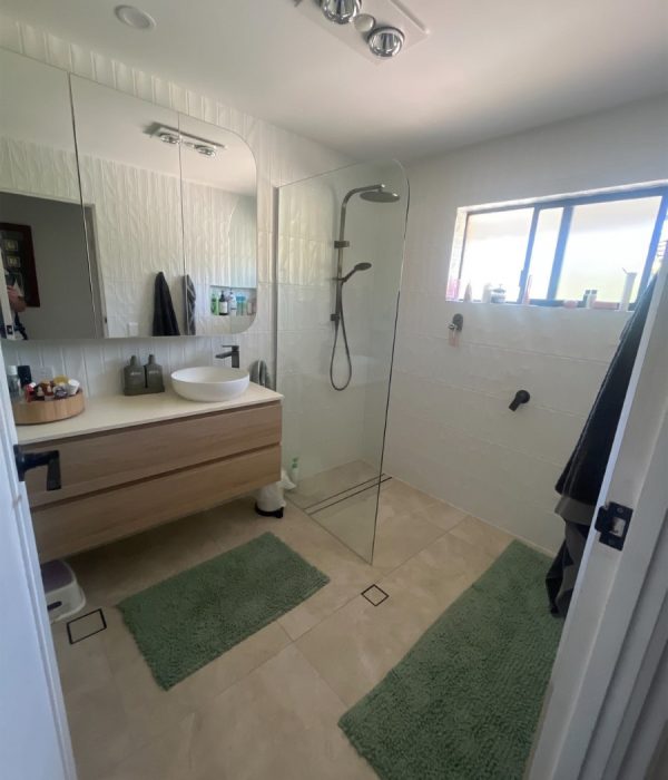 a bathroom with a glass shower and sink