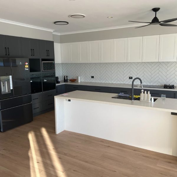 a kitchen with a black and white countertop