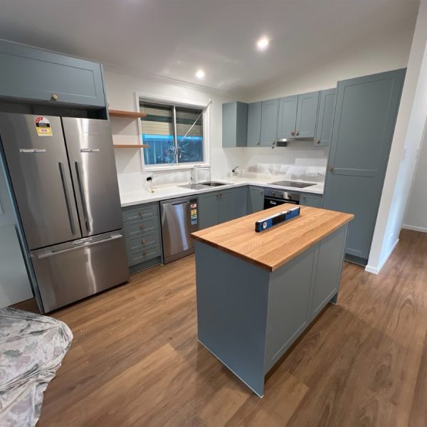 a kitchen with a wood floor and a wood floor